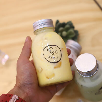 Plastic Milk Tea Bottles Featuring Handle and Screw on Lid Beverage Packaging Solutions with Comfortable Handling