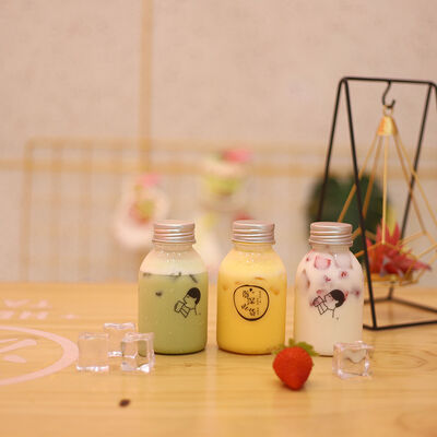 Plastic Milk Tea Bottles Featuring Handle and Screw on Lid Beverage Packaging Solutions with Comfortable Handling