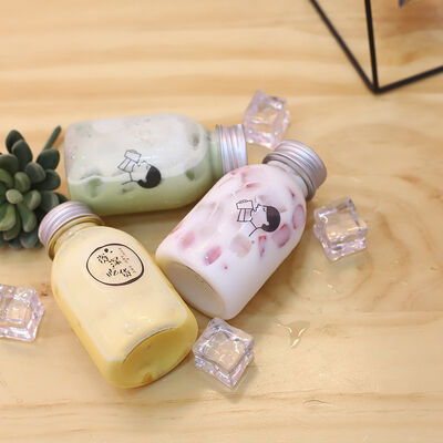 Plastic Milk Tea Bottles Featuring Handle and Screw on Lid Beverage Packaging Solutions with Comfortable Handling